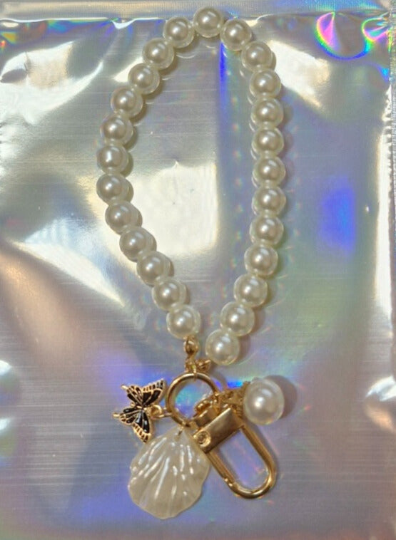 Pearl and butterfly binder charm