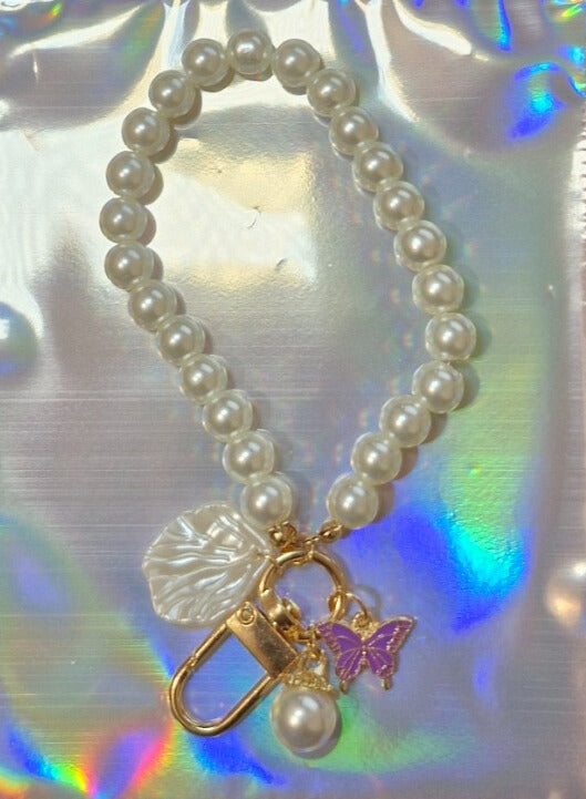 Pearl and butterfly binder charm